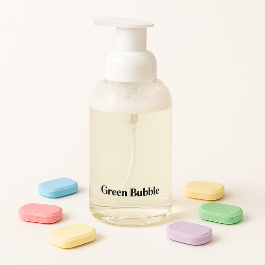 Clear bottle labeled 'Green Bubble' with colorful soap bars on a white background
