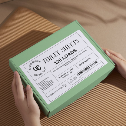 Green box of Eco-friendly toilet cleaning sheets with label on a brown surface