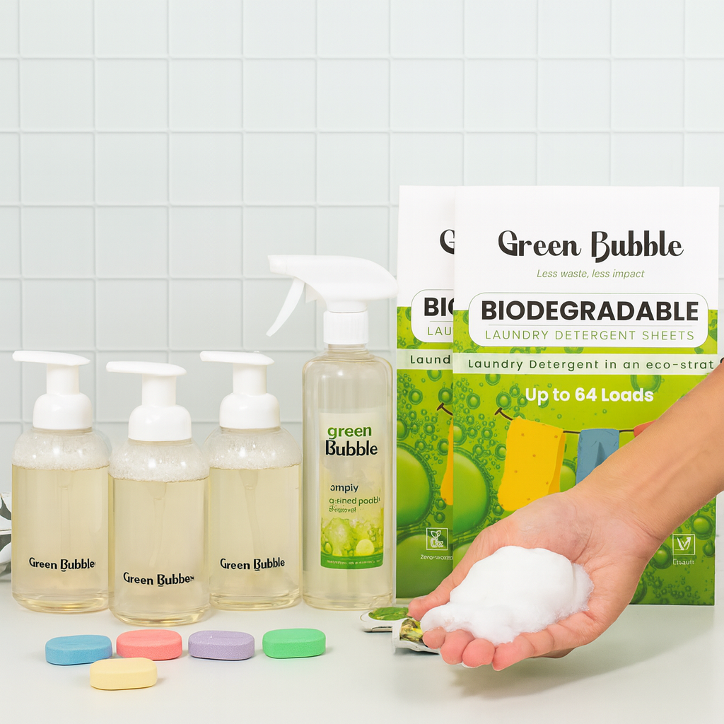 Green Bubble eco-friendly laundry products including bottles, a box of detergent sheets, and a hand holding detergent pods on a tiled background.