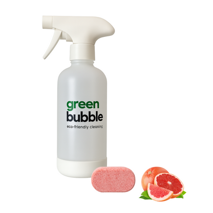 Green Bubble eco-friendly cleaning bottle with a pink cleaning pad and grapefruit slices on a white background