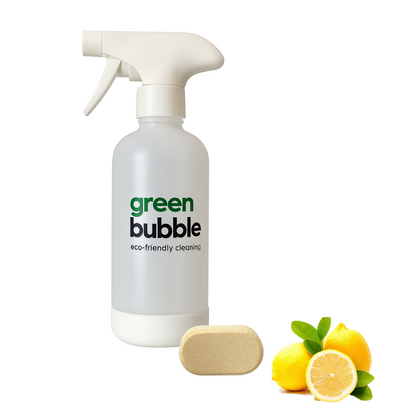 Green Bubble eco-friendly cleaning bottle with a bar of soap and lemons on a white background